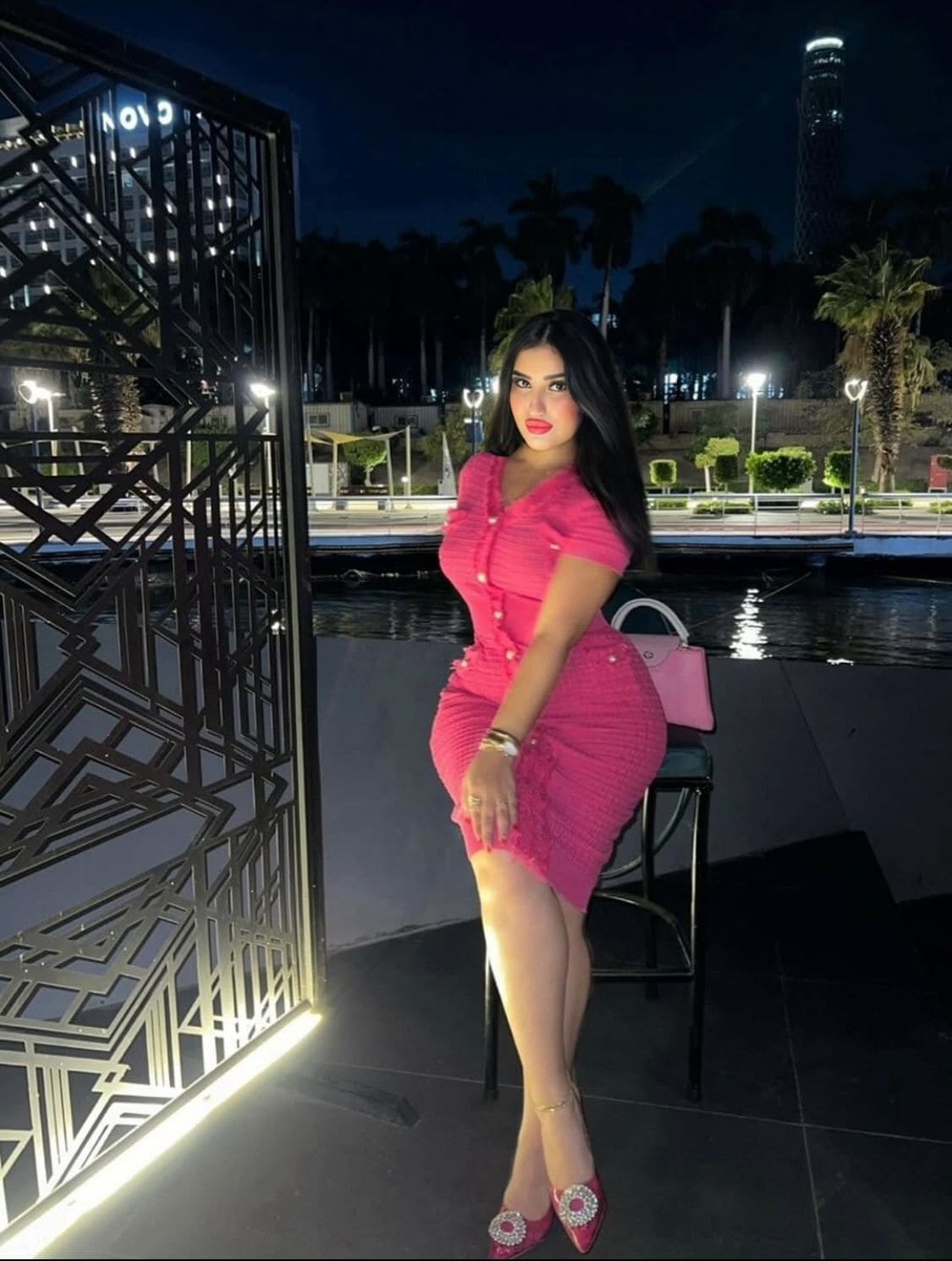 Playful call girl in hotel room chair inviting for romantic booking