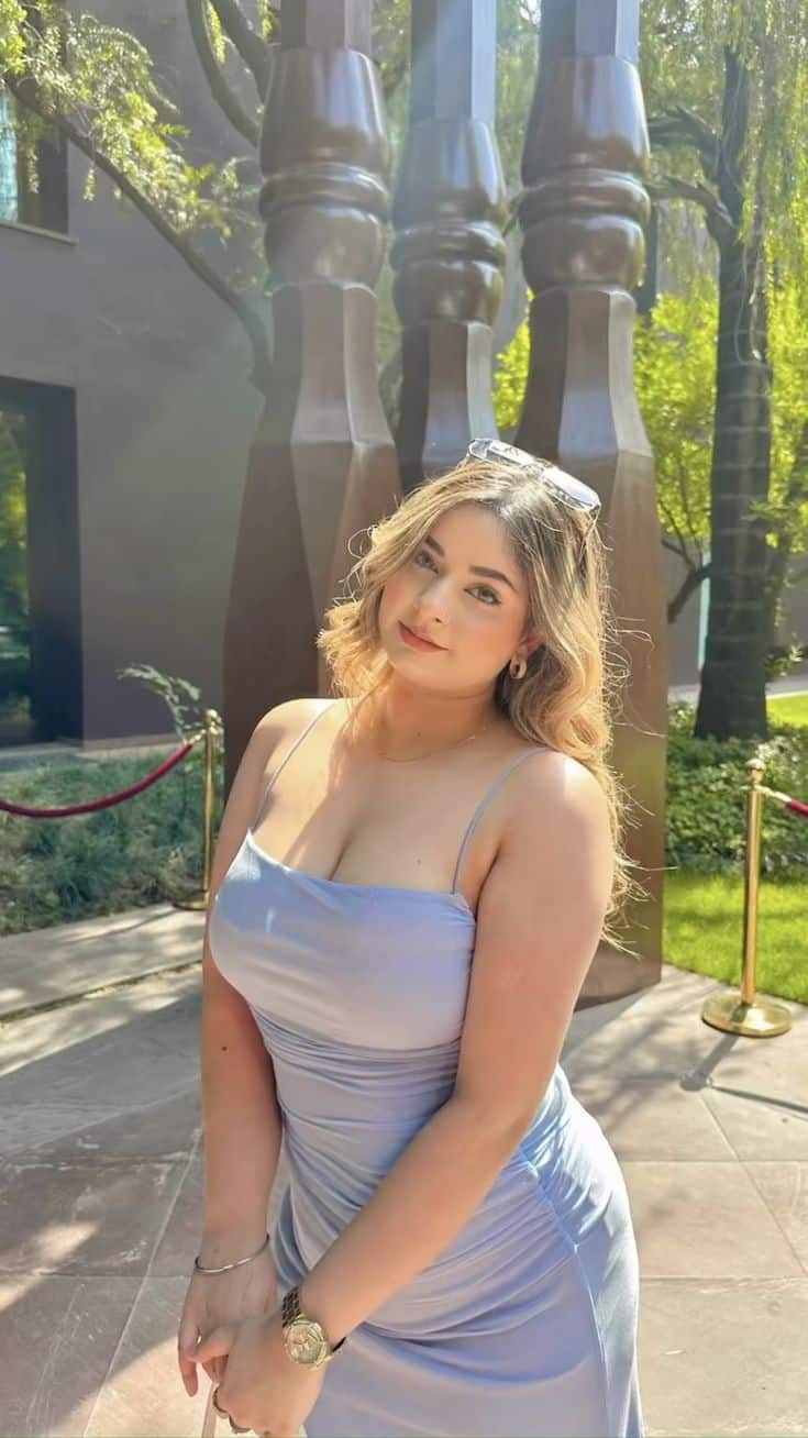 Fun-loving call girl jumping on hotel bed before night-out adventure